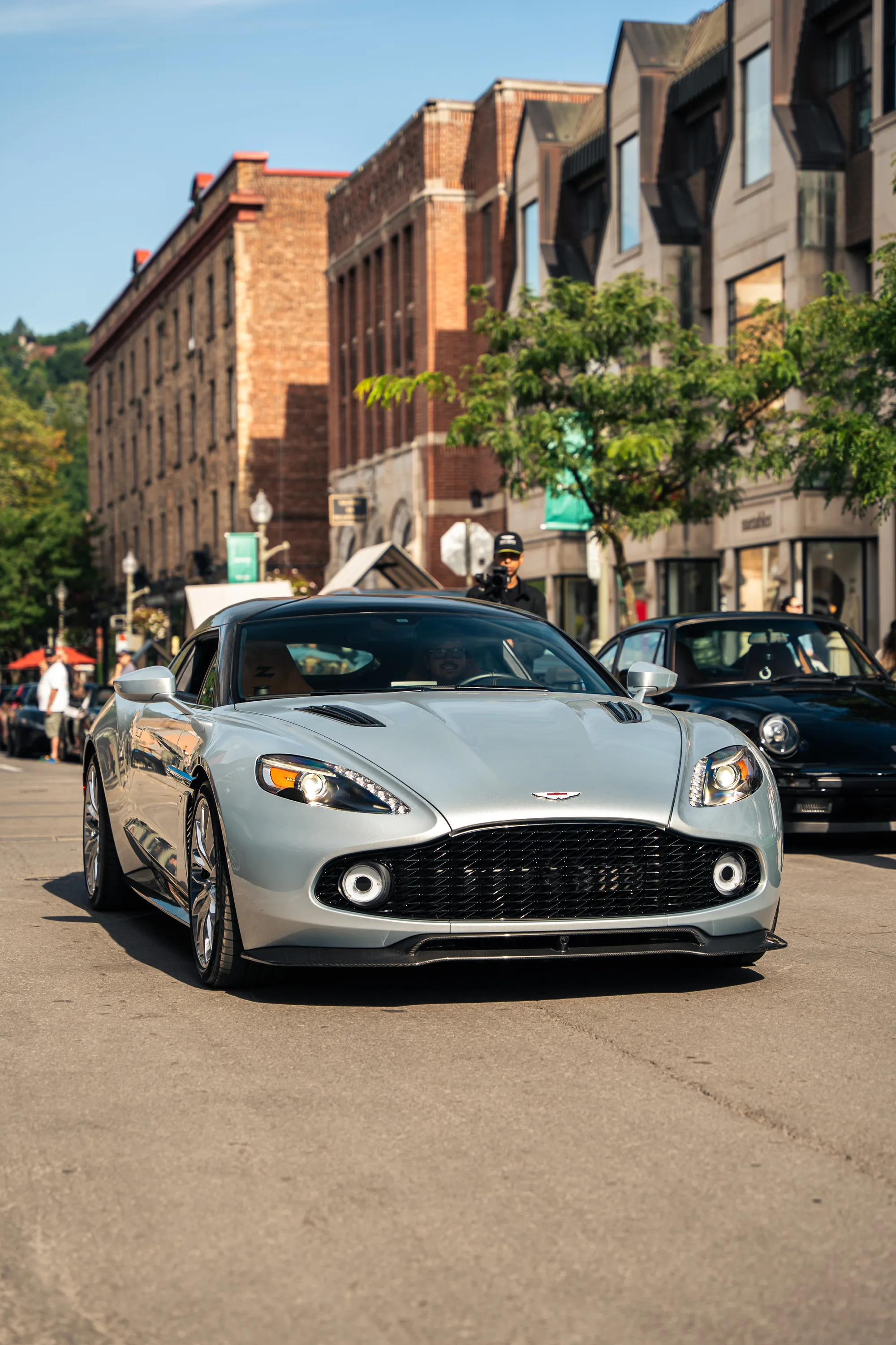 A silver Aston Martin Vanquish Zagato head-on in the middle of Greene Avenue.